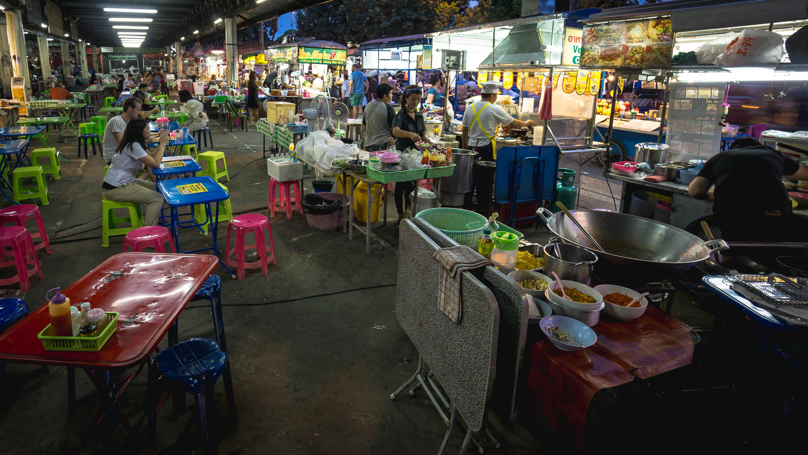 Seating area behind street food vendors in Thailand - Find Away Photography